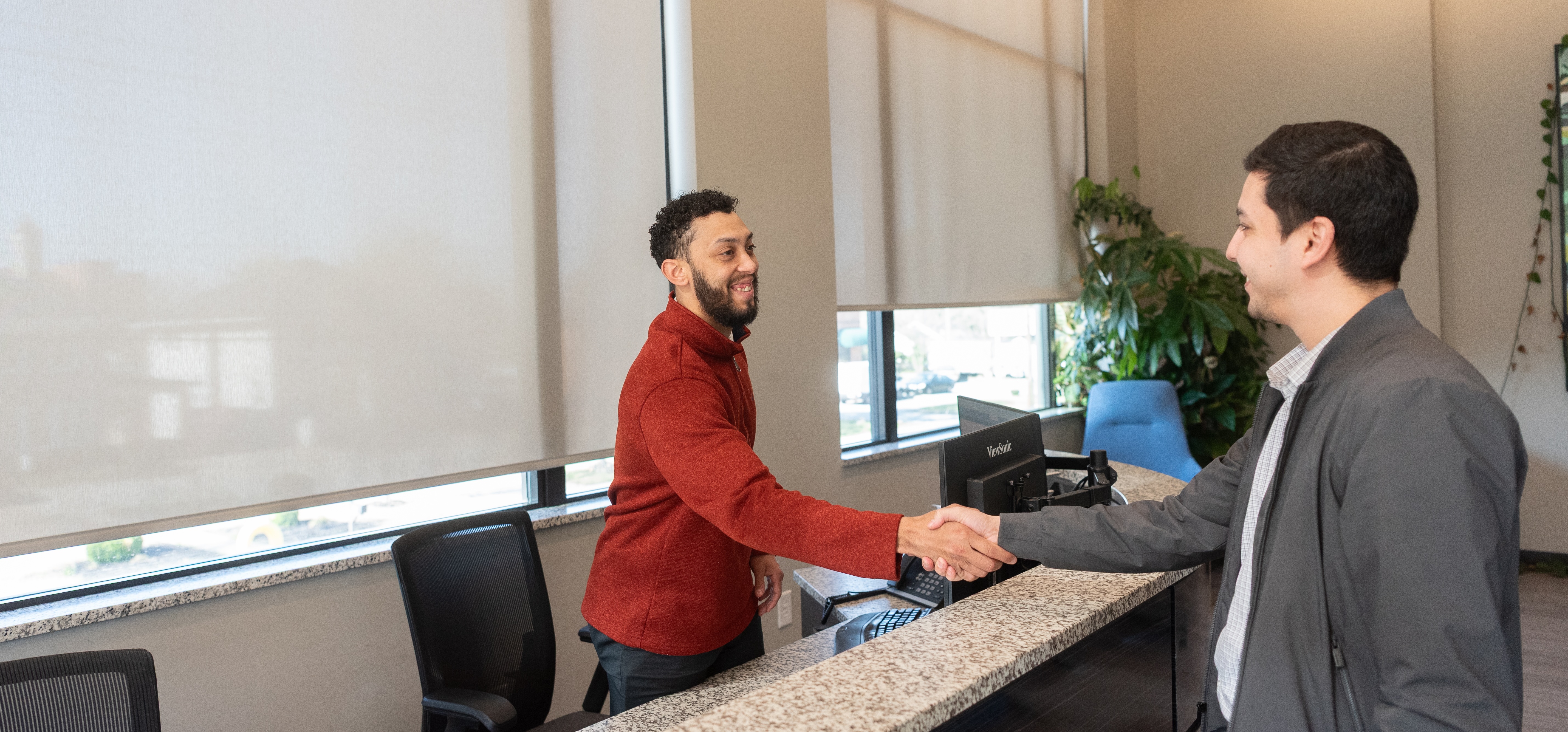 shaking hands at front desk